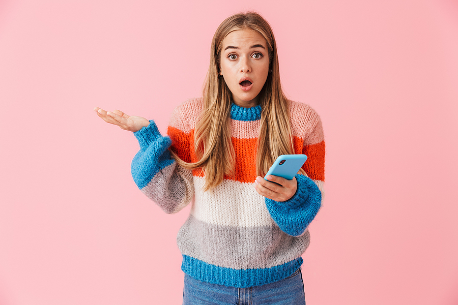 Young woman holding blue mobile phone looking as if she's asking a question.