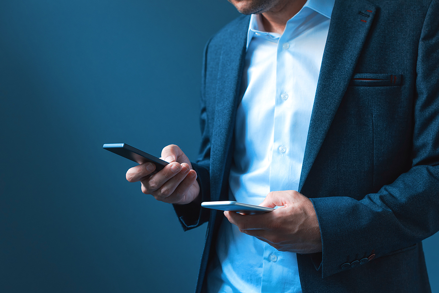 Man holding two phones.