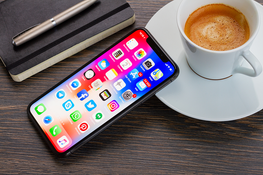iPhone leaning against cup of coffee