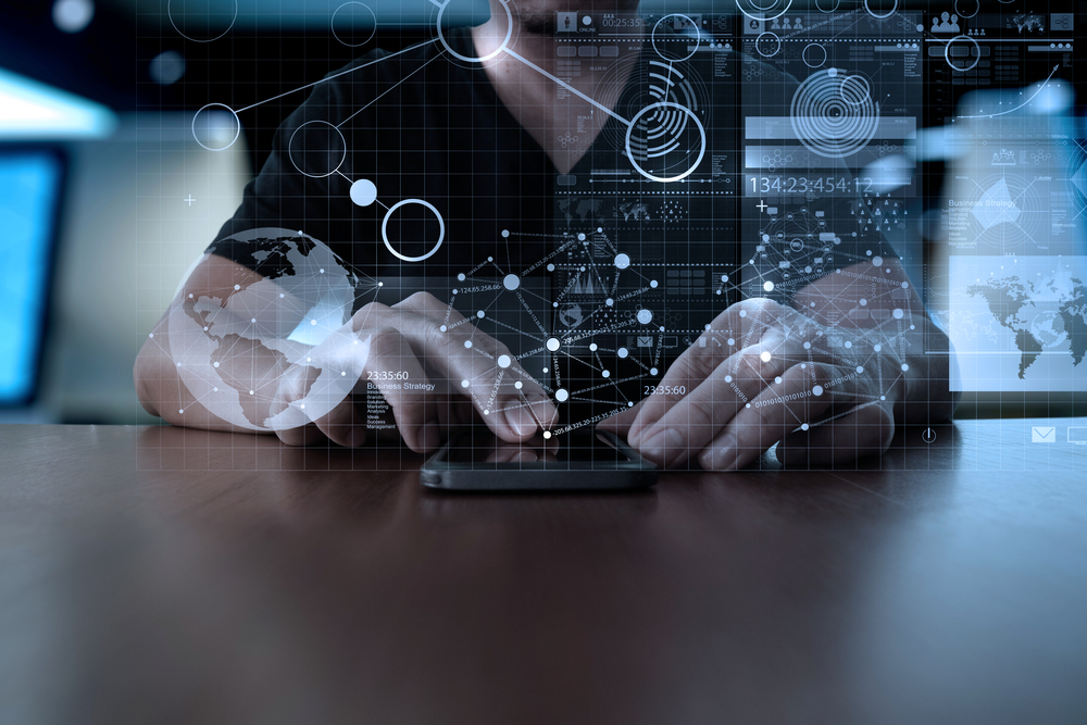 blueprint on top of hands using a mobile phone