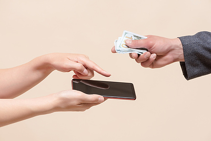 Exchanging mobile phone for money.