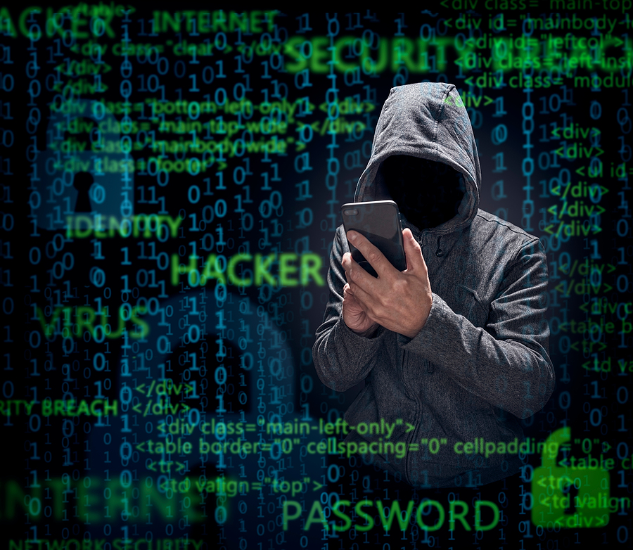 person wearing a sweatshirt with their hood up holding a mobile phone surrounded by coding phrases